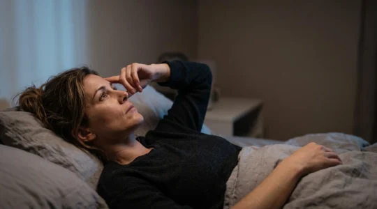 Professionnel allongé les yeux ouverts dans le noir, esprit envahi par des pensées de travail qui l'empêchent de dormir